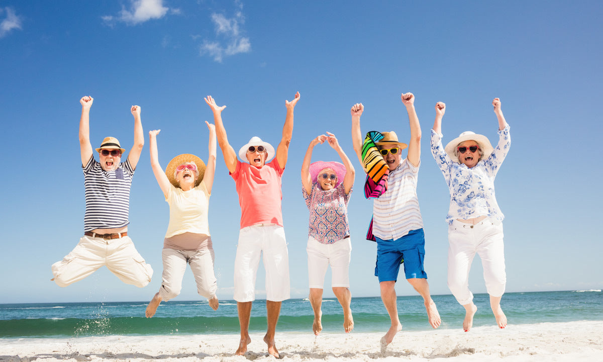 A group of friends laughing together on the beach