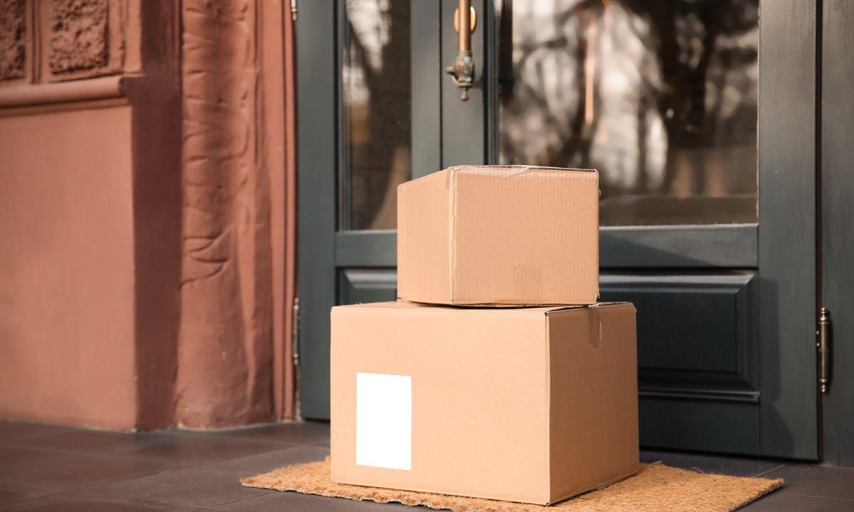 delivered parcels on doormat near glass door