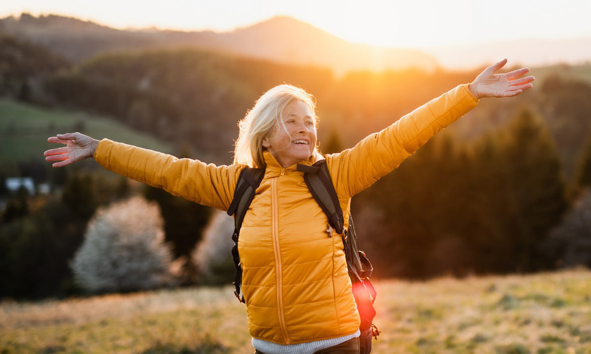happy female hiker with outstretched arms