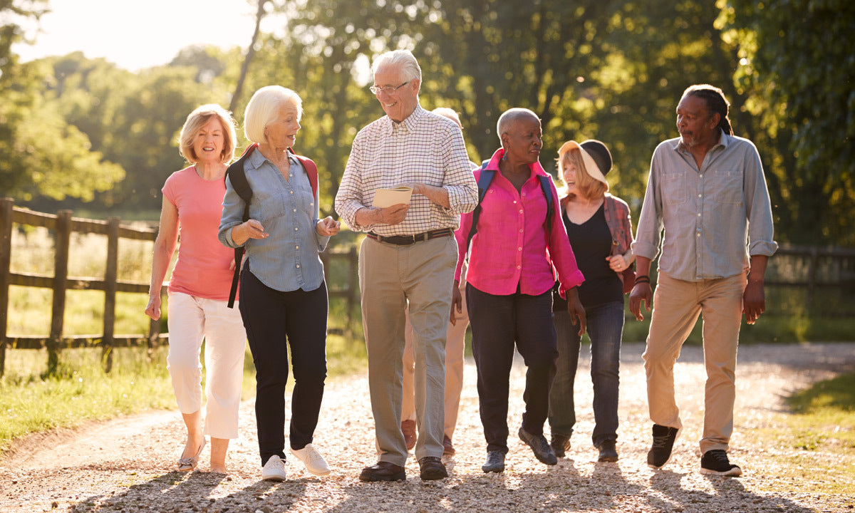 senior friends walking in countryside