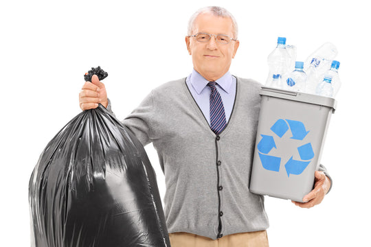 senior man holding recycling bin and full garbage bag