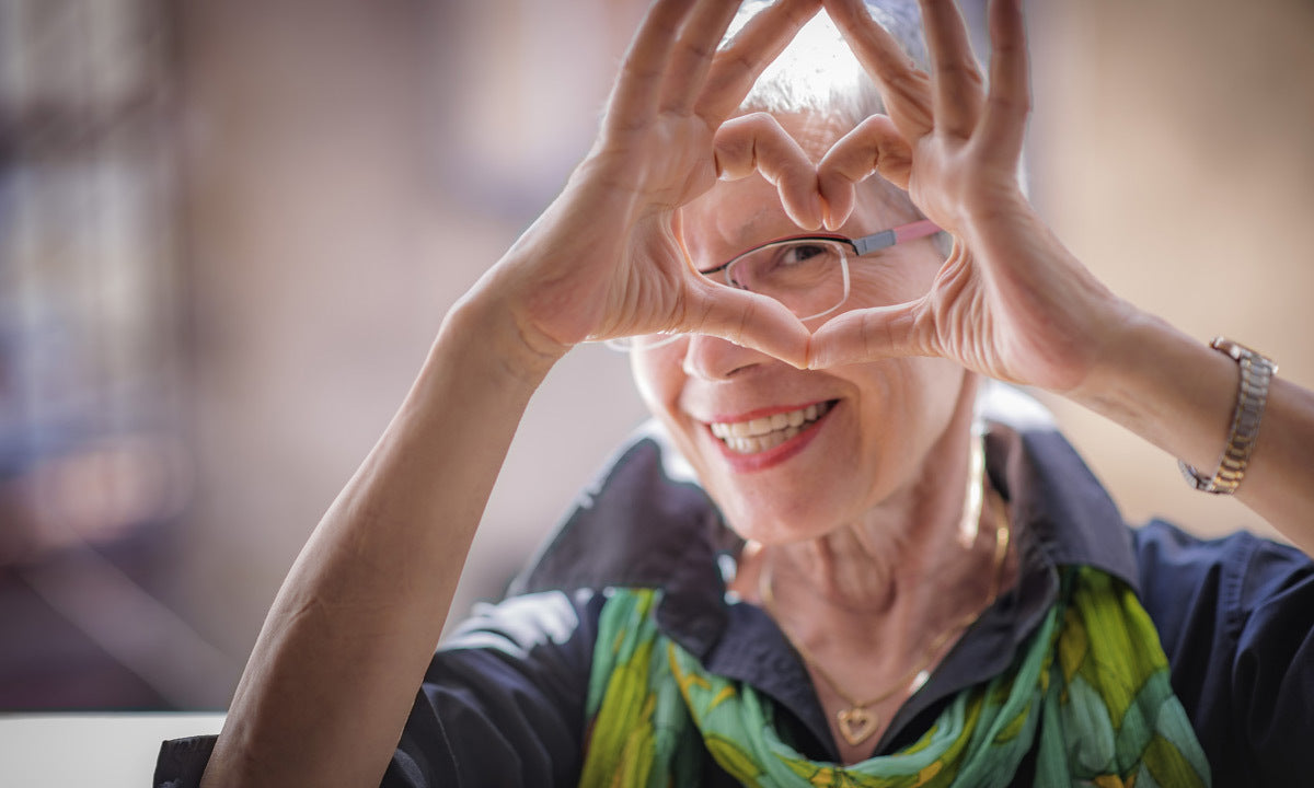 senior woman making heart